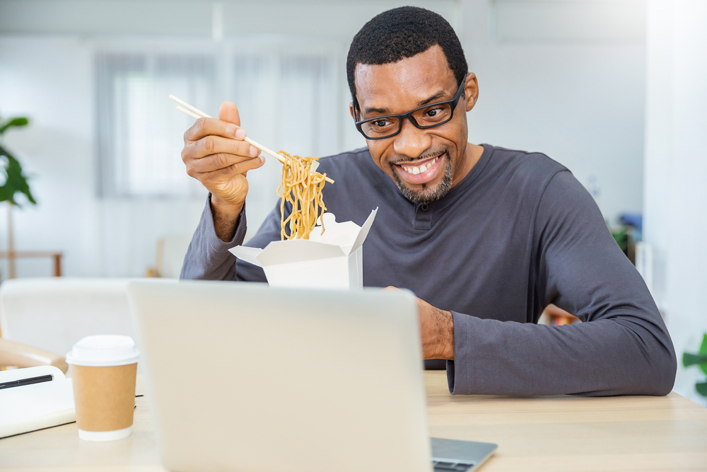 black-man-eating-during-virtual-meeting