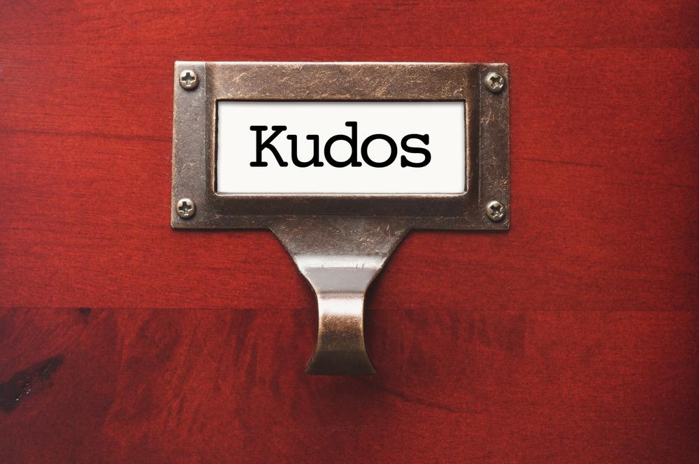 kudos written in black on red wooden box